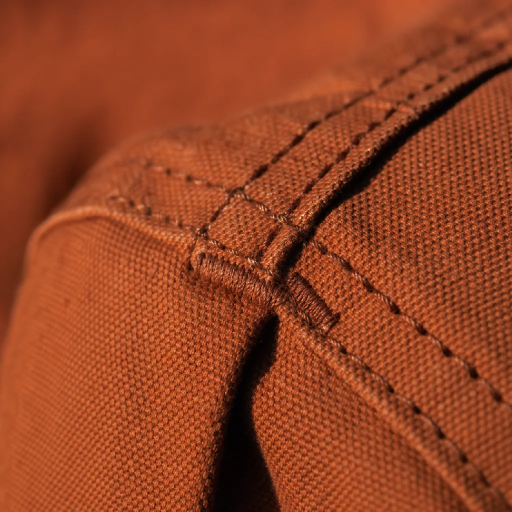 Detail of the welding jacket's reinforced shoulder seam and heavy topstitching.